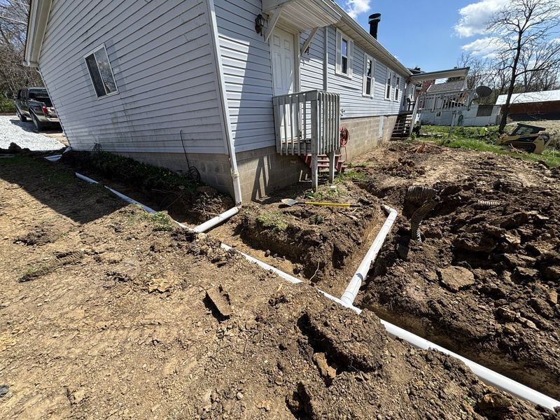 French drain and rain leader installation around a Pittsburgh area home foundation